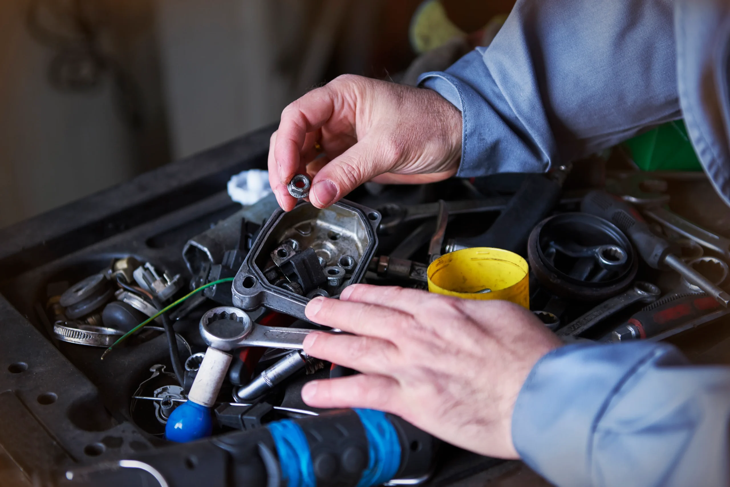 A professional inspecting the car for car battery for replacement.